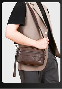 Close-up of LINKENROO dark brown textured leather crossbody bag with metal zippers