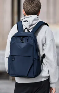 Detail of dark blue nylon backpack featuring a side USB port and elastic side pocket