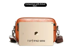 Brown lychee texture cross-body bag size comparison with a 7.9-inch iPad mini
