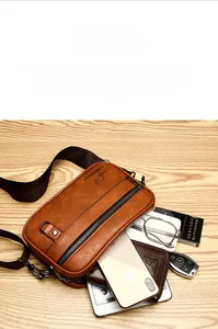 Detailed view of brown lychee texture leather bag with multi-compartment storage space