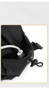 Detail of the men's chest bag showing a built-in USB charging port and metal eyelet