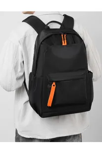 Detail of waterproof black backpack showing orange zipper cords and padded shoulder straps