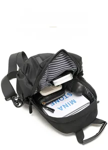 Detailed view of the black crossbody bag's spacious interior with striped lining