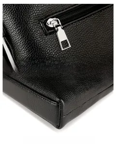 Detail of silver zipper and reinforced corners on black lychee grain leather briefcase