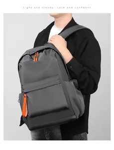 Side view of gray waterproof oxford backpack with vibrant orange zippers and side pocket