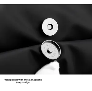Macro view of silver magnetic hardware with texture on black minimalist laptop backpack