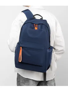 Detail of waterproof navy oxford backpack featuring contrasting orange zipper pullers