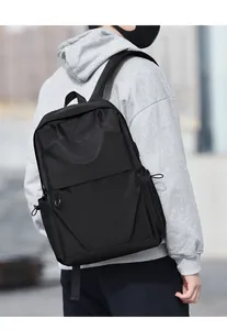 Close-up of black waterproof business backpack with side drawstring pocket and main compartment
