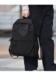 Close-up of minimalist black business backpack in water-resistant nylon fabric