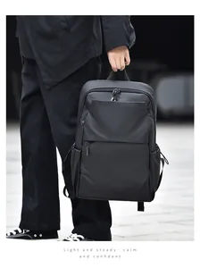 Man holding black versatile business backpack with matte finish and durable zippers