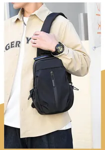 Close-up of waterproof black chest bag featuring multiple zippers and adjustable strap