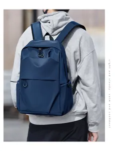 Side view of blue waterproof nylon backpack with drawstring side pockets on male model