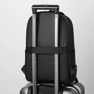 Black business laptop backpack with back luggage strap mounted on suitcase handle