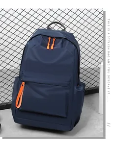 Detail view of navy Oxford canvas backpack showing high-contrast bright orange zippers