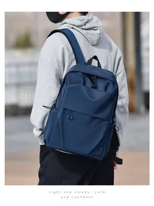 Navy blue travel backpack with waterproof nylon fabric shown on male model from a side view