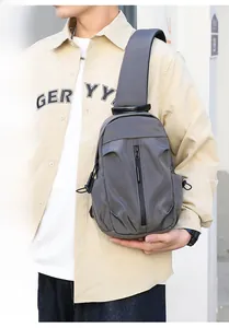 Side view of grey water-repellent nylon chest bag for men shown on a model