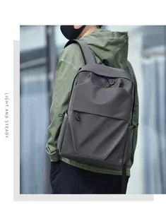 Modern grey large capacity business backpack for men worn by model in urban setting.