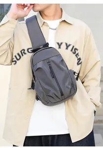 Detail of grey men's chest bag with high-density fabric and vertical zipper pocket
