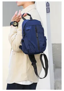 Detail of waterproof dark blue nylon sling bag featuring a vertical black zipper pocket