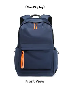 Front detail of navy blue nylon backpack with contrasting orange zipper pulls for men