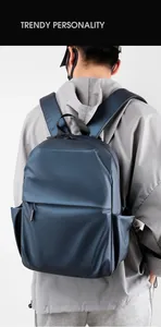 Detail of waterproof dark blue men backpack shown on model for daily business use
