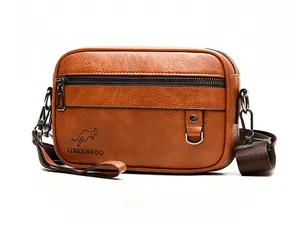 Detail view of brown textured leather shoulder bag with buckle pocket and logo