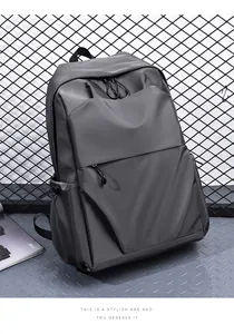 Detail of dark gray water-resistant backpack fabric and side drawstring pocket detail