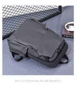Top view of a grey minimalist laptop backpack with black zippers and yellow accents