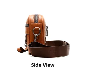 Side profile of brown leather cross-body bag showing zippered pockets and nylon strap
