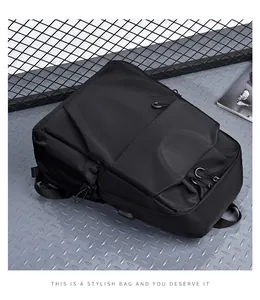 Detail view of black waterproof backpack featuring layered zip pockets and adjustable straps