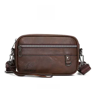 Detail view of brown leather shoulder bag featuring textured finish and logo engraving