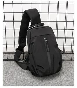 Detail of black tactical sling bag featuring breathable mesh strap and vertical zipper