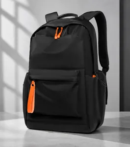 Detail view of water-resistant nylon backpack with vibrant orange zipper pullers and breathable mesh back