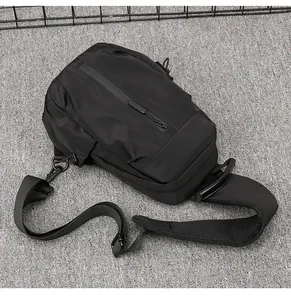 Detail of waterproof zipper and breathable mesh strap on black travel chest bag
