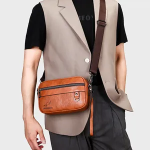 Men's vintage brown leather crossbody bag with adjustable nylon strap and metal hardware