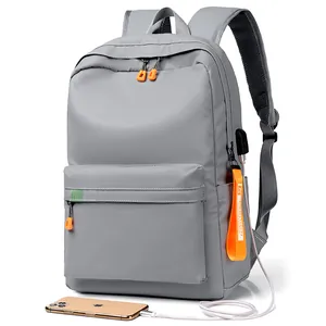 Large gray minimalist backpack with USB charging port and stylish orange accents