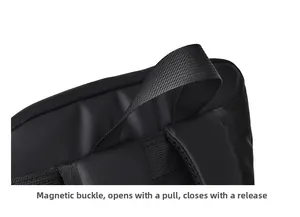 Detail of waterproof black backpack showing magnetic buckle and reinforced handle