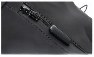 Detail of waterproof zipper and ergonomic matte puller on the black travel backpack