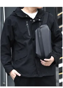 Close-up of black tactical chest bag with brand lettering and magnetic buckle detail