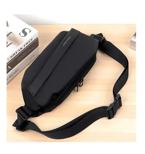 Detail of black waterproof nylon crossbody bag with metal zipper on wooden table