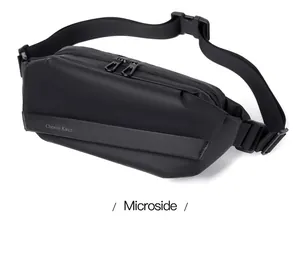 Detail view of the black men's chest bag featuring a waterproof matte texture and dual zippers