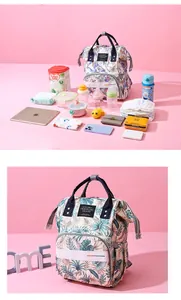 Detail of large capacity diaper backpack with waterproof leaf print and storage compartments
