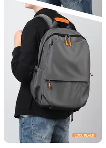 Side view of cool black backpack with orange accents shown on model for daily commute