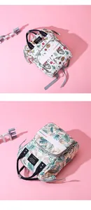 Detail showing two stylish floral print diaper bags with multiple storage pockets