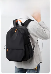 Detail of black backpack with USB charging port showing smartphone connection in use
