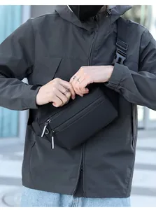 Gros plan sur le tissu imperméable mat et le zip réfléchissant du sac de poitrine noir