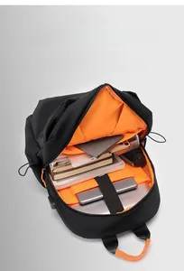 Detailed top view of black backpack featuring orange lining and laptop storage compartments