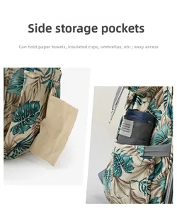 Detail of side pockets on tropical leaf diaper bag showing storage for tissues and umbrella