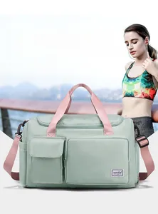 Macro shot of mint green waterproof travel bag featuring multi-layer storage and luggage strap