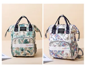 Detail view of large capacity diaper backpacks in tropical palm and unicorn floral prints